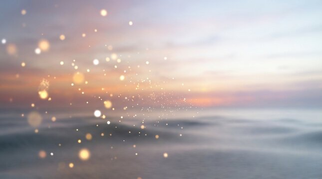 Abstract blurred sunset over ocean with ethereal golden bokeh and sparkling particles
