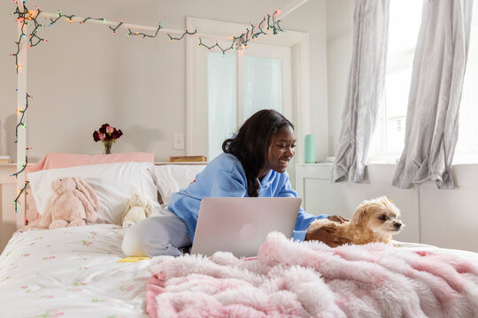 Teen black girl  laptop computer dog