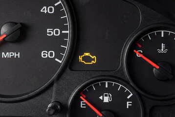 Illuminated check engine light on a car dashboard
