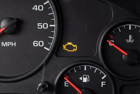 Illuminated check engine light on a car dashboard