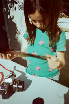 Child Examining Film Strip