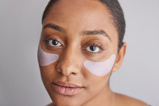 Model wearing eye patches on her face