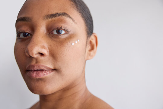 Model with a skin cream on her face