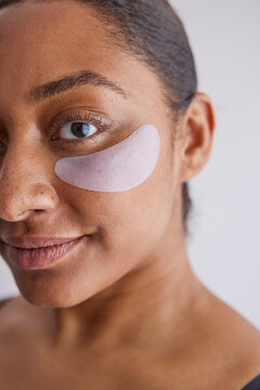 Model wearing eye patches on her face