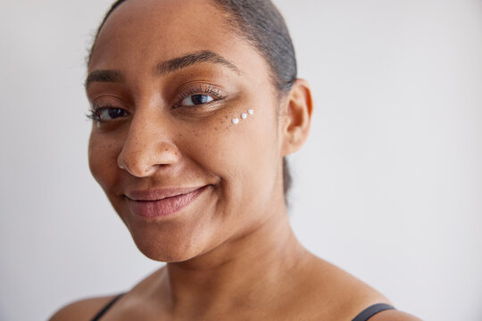 Model with a skin cream on her face