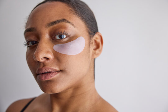 Model wearing eye patches on her face