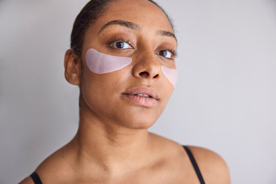 Model wearing eye patches on her face