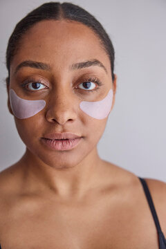Model wearing eye patches on her face