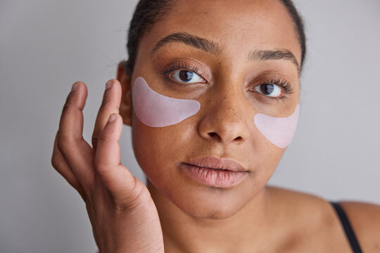 Model wearing eye patches on her face