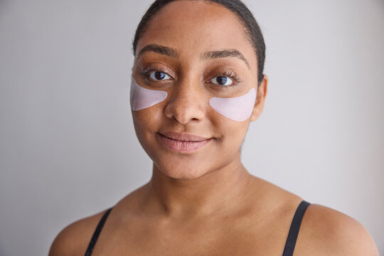 Model wearing eye patches on her face