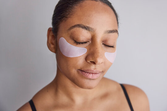 Model wearing eye patches on her face
