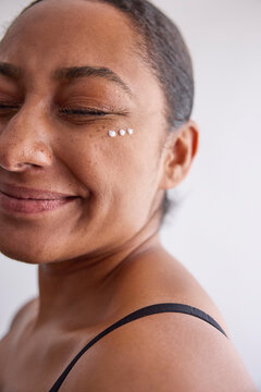 Model with a skin cream on her face