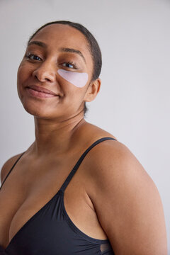 Model wearing eye patches on her face