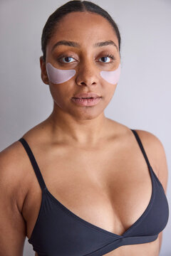 Model wearing eye patches on her face