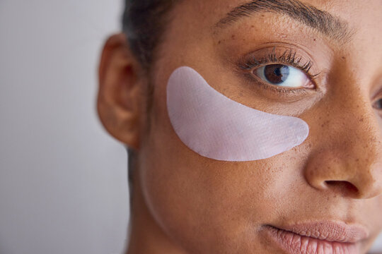 Model wearing eye patches on her face