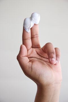 A hand with a dollop skincare cream