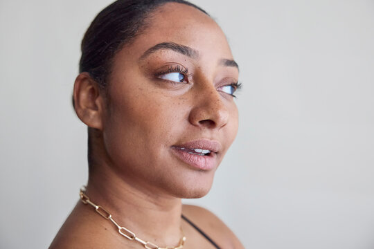 Beautiful model in studio wearing bra and jewelry