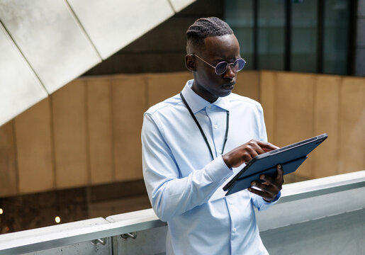 Businessman Using Devices in Modern Workplace