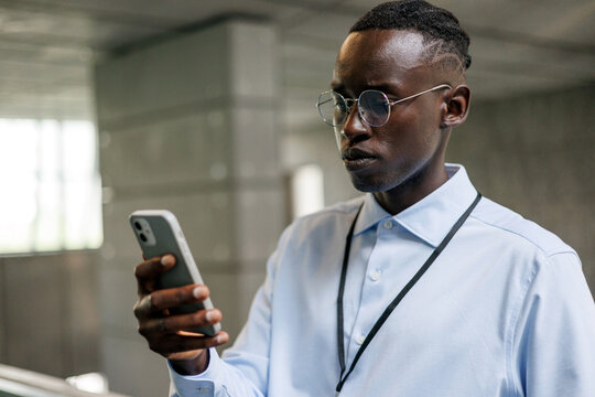 Focused Professional Man Reading on Phone