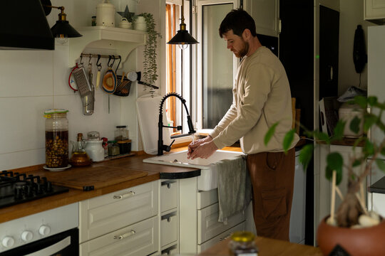 Man rinsing produce kitchen