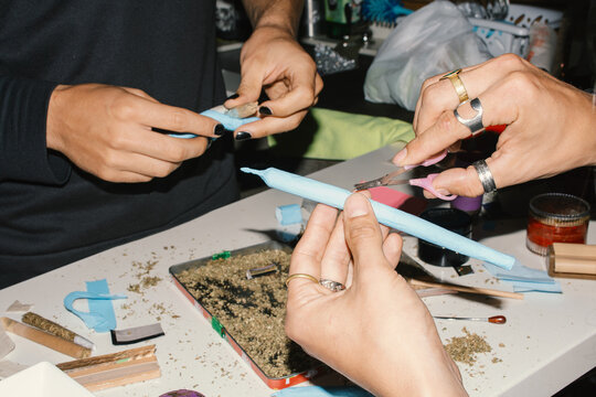 two friends rolling joints 