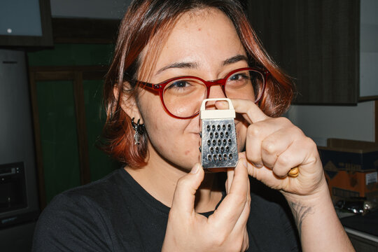woman holding small grater kitchen cooking 