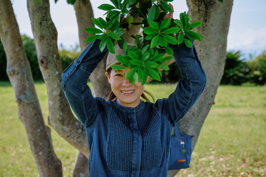 A radiant smile framed by leaves.