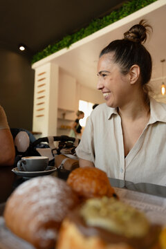 Woman enjoying coffee and pastries at a cafe