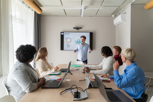 Man Sharing Insights With Team At Business Meeting