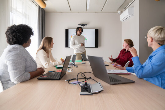 Colleague Sharing Insights At Business Meeting