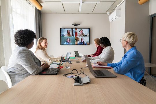 Brainstorming At Hybrid Meeting with Team and Virtual Colleagues
