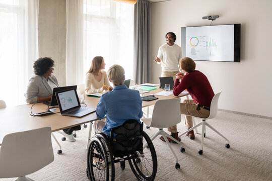 Man Sharing Insights With Team At Business Meeting