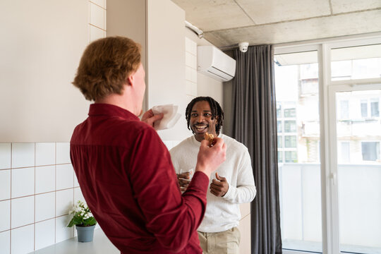 Cheerful Kitchen Chat Between Colleagues