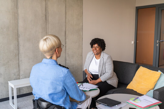 Coworkers Conversation in Modern Office