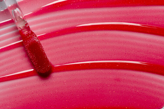 Lip oil, liquid red lipstick. Cosmetic product for lip moisturizing.