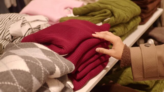 Shopping for sweaters in a clothing store in autumn