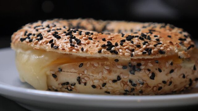 Enjoying a tasty bagel with sesame seeds at breakfast time