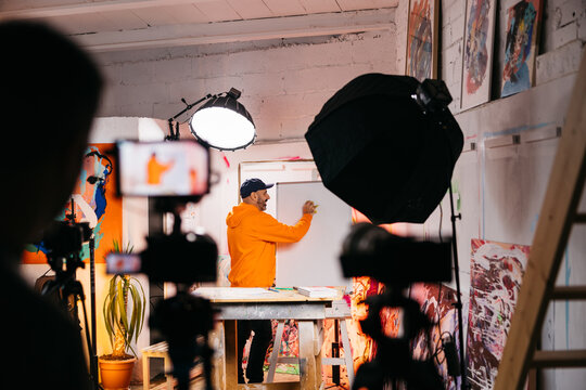 Man recording art class in studio
