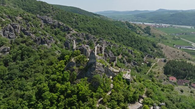 Aerial view of the ruins of an old fortress in Durnstein Austria surrounded by the Wachau Valley landscape and the Danube River in a scenic tourist region