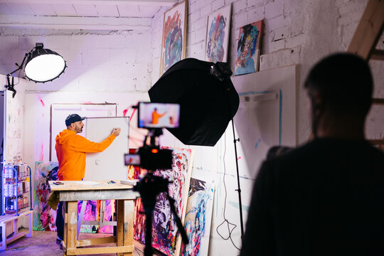 Artist drawing on whiteboard for livestream

