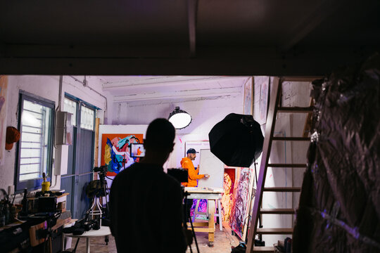 Wide view of artist teaching at whiteboard

