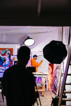 Artist explaining diagram on whiteboard

