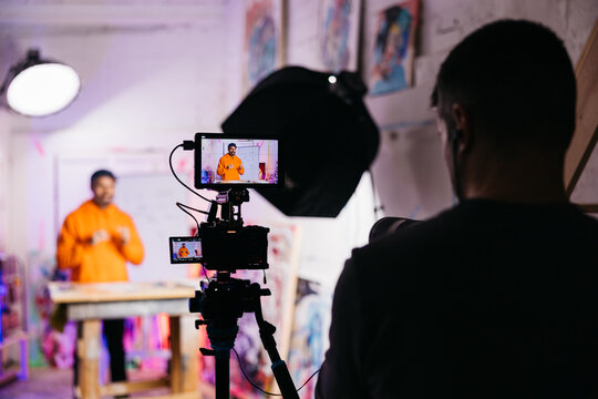 Camera filming artist during whiteboard lesson

