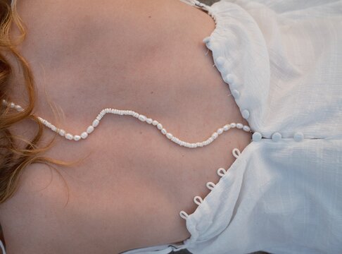 Redheaded Girl with Pearls on Spine