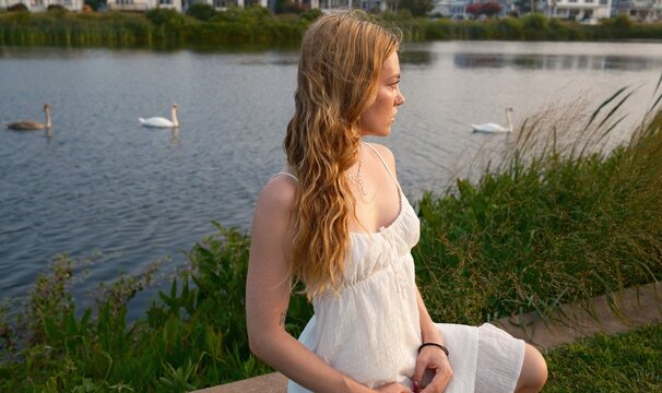 Girl with Swans at Sunset on Lake