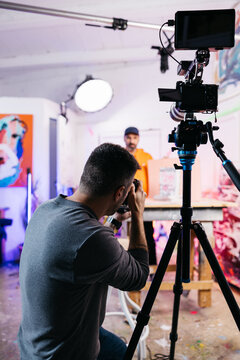 Photographer working with client

