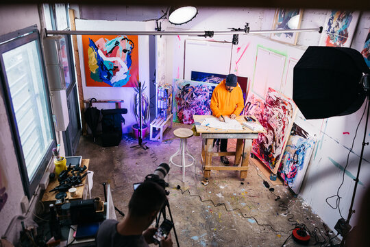 Overhead view of artist drawing in studio

