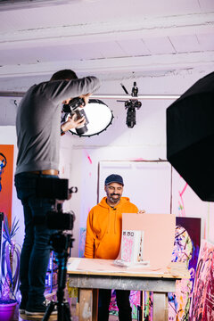 artist and photographer  Photographing book with pink backdrop

