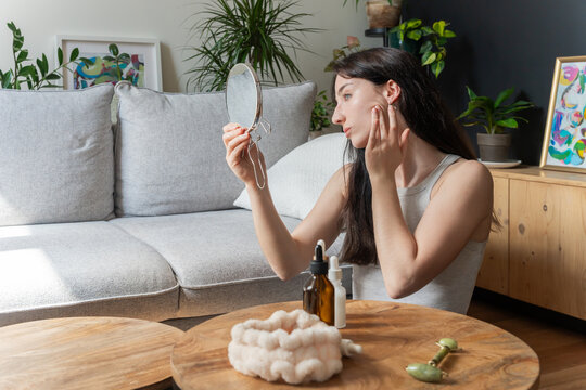 Woman Checking Skin With Mirror