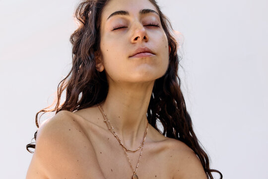 Young woman wearing a golden necklace outside 